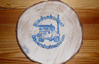 Holzscheibe mit Stempel vom Hof