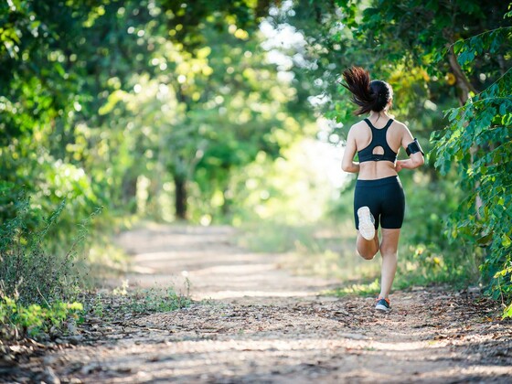 Young fitness woman running on a rural road. Sport woman running,Healthy lifestyle concept.