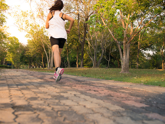 Young woman running in wood, training and exercising for trail run marathon endurance in morning sunrise. Fitness healthy lifestyle concept. Vintage effect style pictures.