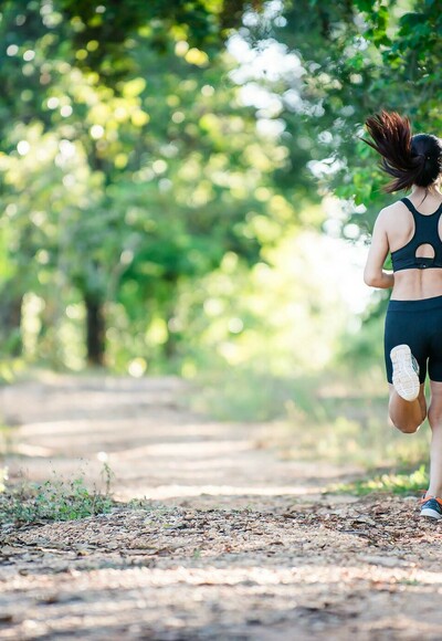 Young fitness woman running on a rural road. Sport woman running,Healthy lifestyle concept.