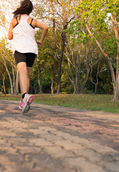Young woman running in wood, training and exercising for trail run marathon endurance in morning sunrise. Fitness healthy lifestyle concept. Vintage effect style pictures.