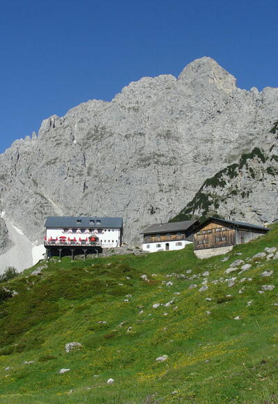 Die Gruttenhütte, im Hintergrund der Treffauer, einer der höchsten Gipfel des Kaisergebirges.