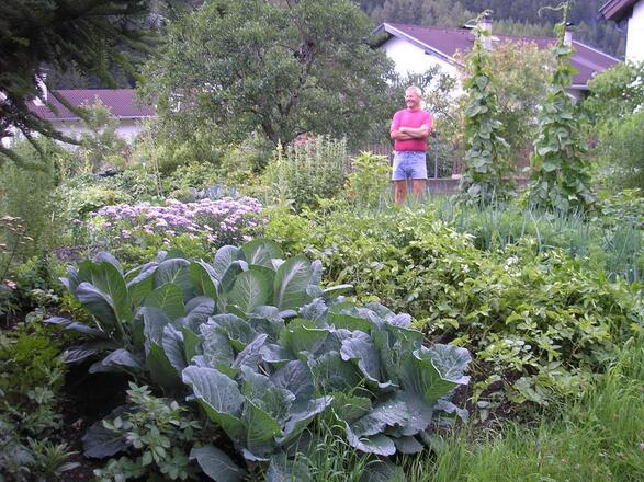 Stolze Hausherr und Koch in seinem Garten
