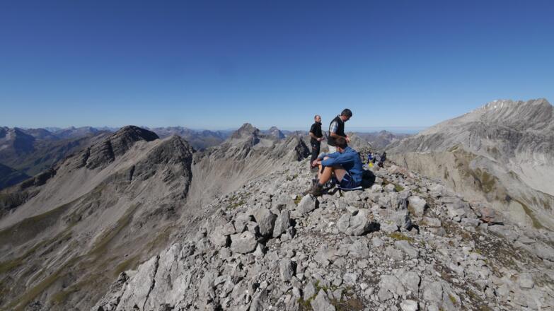 Gipfelrast vor einer beeindruckenden Bergkulisse