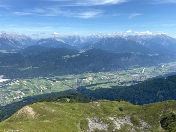 Das Tiroler Inntal, dahinter das Seefelder Plateau und die bleichen Berge des Karwendels liegen einem zu Füßen.