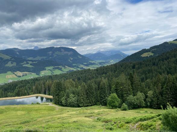 Blick hinunter über den Beschneiungsteich in den Talboden von Fieberbrunn.