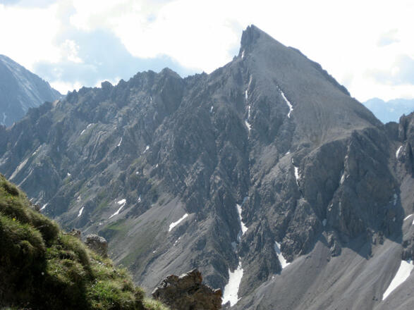 Der zackige Ostgrat links, der steile Westflankenabstieg bis in die Schuttrinne ganz rechts
