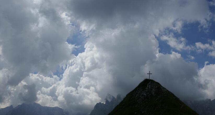 Gipfelkreuz des Mahnkopf bei unsicherer Wetterentwicklung