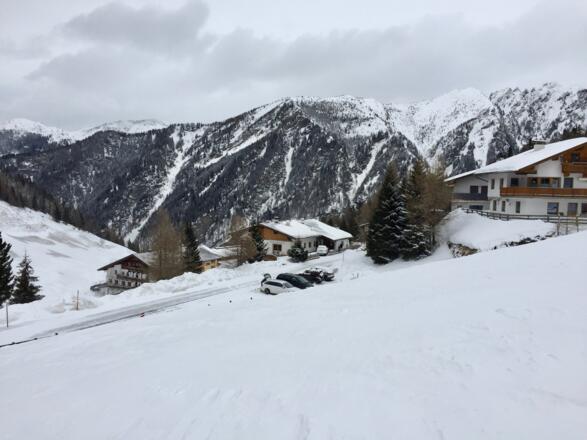 Blick zurück zum Parkplatz in Padaun, dem Ausgangspunkt zur Vennspitze. Unten links grüßt der Gasthof Steckholzer herauf.