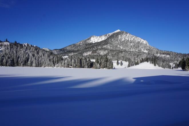 Blick am Morgen über den winterlichen Spitzingsee zum Brecherspitz