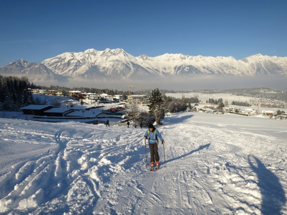 Start vom Parkplatz in Richtung Gasthaus Lärchenwald. Hinten die Nordkette (Karwendel).