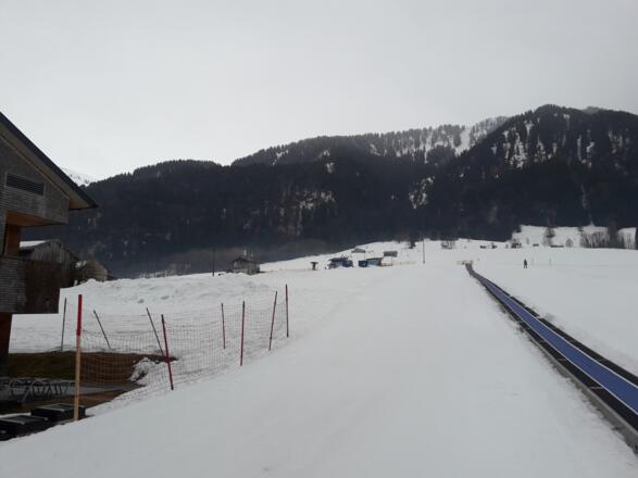 Hier geht es rechts am Skilift nach oben bis zum Waldrand