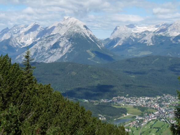 Blick vom Steig unterhalb der Nördlinger Hütte auf Seefeld. Dahinter die Hohe Munde und die Zugspitze.